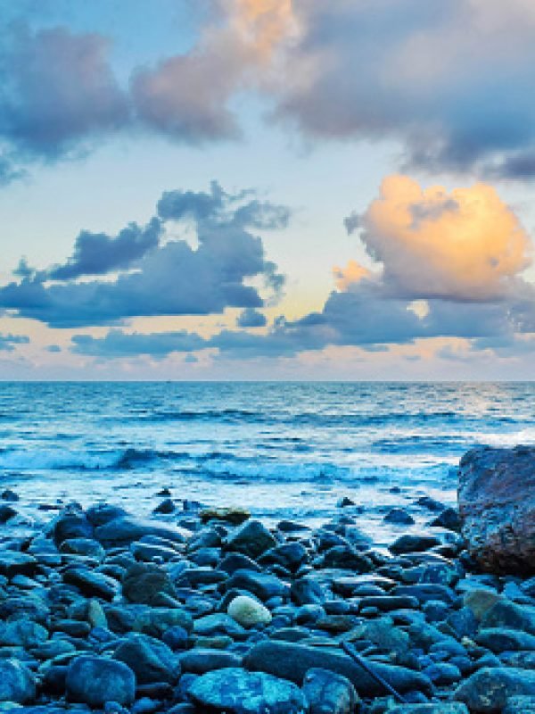 In the frame the beach is comprised of only pebbles. Blue water and Orange sky after the sunset has given the frame a perfect finishing